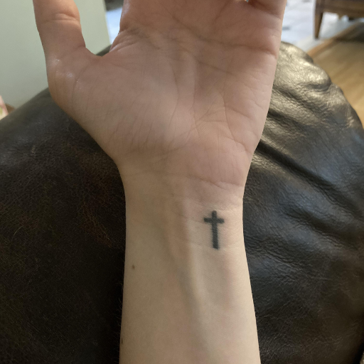 Are there any considerations before getting a cross tattoo